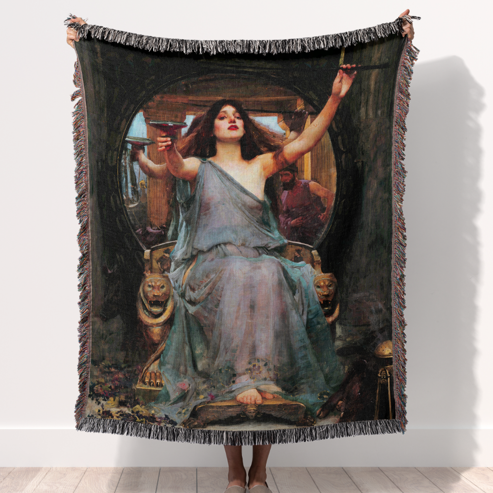 person holding up a woven throw blanket featuring William Waterhouse's painting, "Circe Offering the Cup to Ulysses."