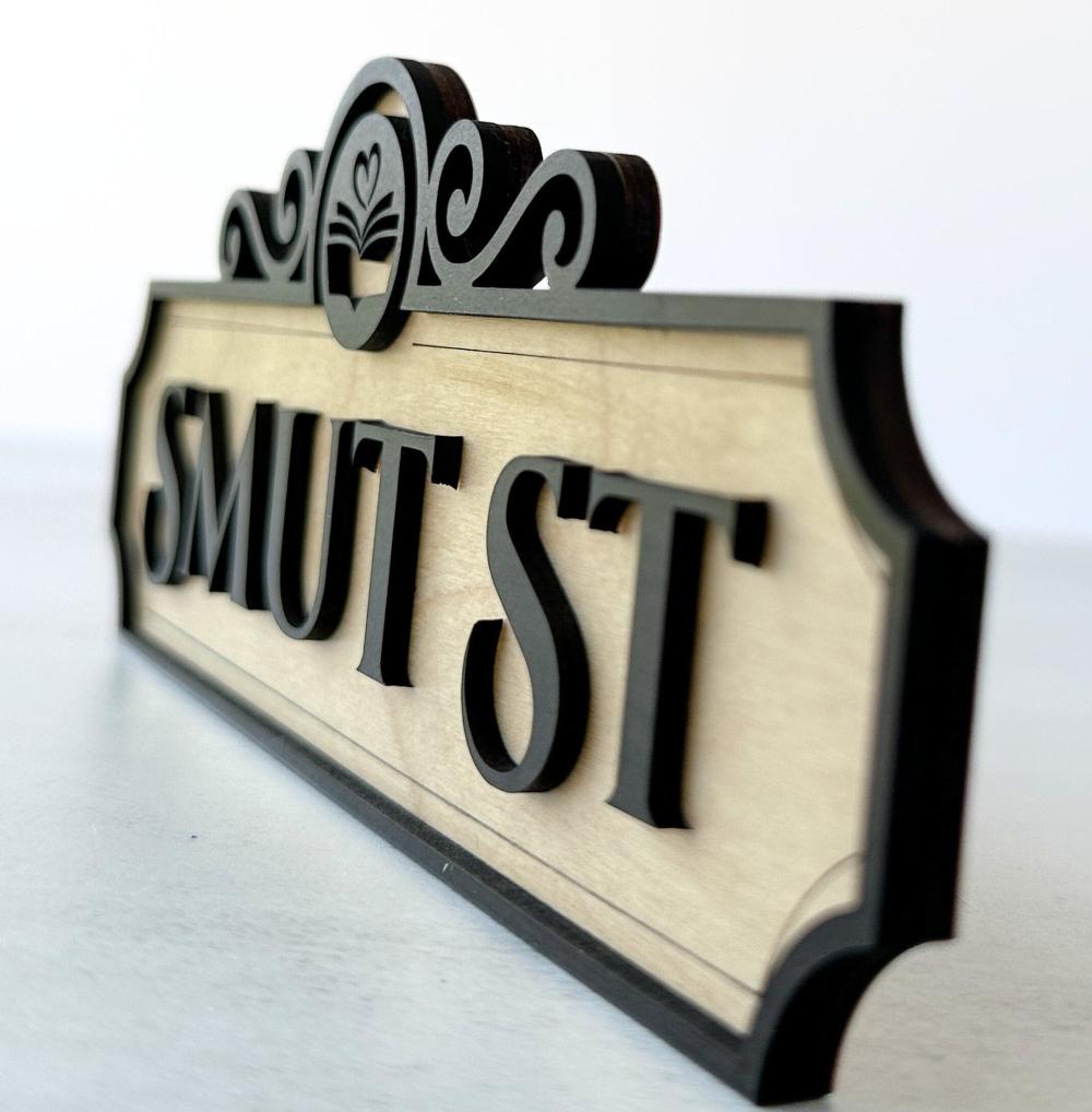 side view of a smut st bookshelf sign made from wood in 3d layered vintage inspired style