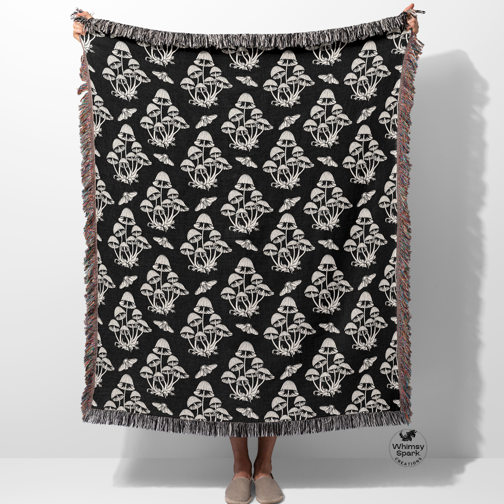 Person holding up a woven mushroom pattern blanket with fringe